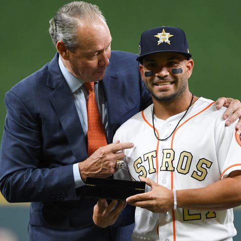 Astros owner Jim Crane presents Jose Altuve with h