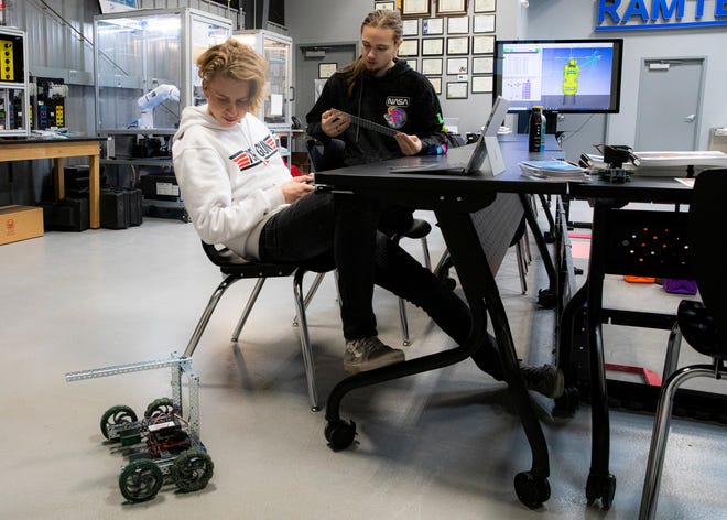 Unioto senior Ashton Kinnison, left, uses a remote control to show the versatility of a robot he and Isaac Butterbaugh are working on for their RAMTEC class at Pickaway-Ross on Feb. 13, 2020. The robot will compete with others in the class and possibly in the nation for Skills USA Urban Search and Rescue competition where robots will be used to remove explosive devices to safety.  