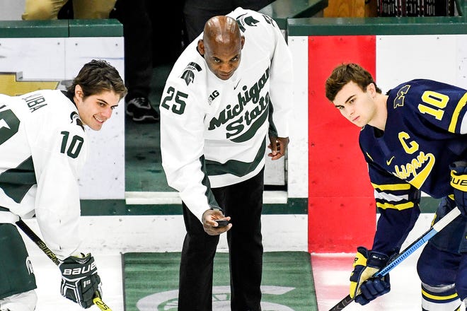 Michigan State's head football coach Mel Tucker, center, prepares to drop the puck before the Spartans game against Michigan on Friday, Feb. 14, 2020, at the Munn Ice Arena in East Lansing. At left, MSU's Sam Saliba and Will Lockwood look on.