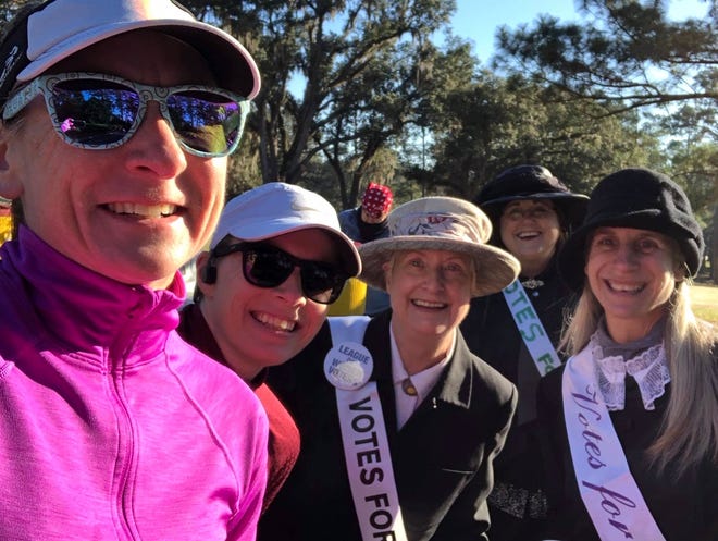 League of Women Voters members cheer on runners at the 2020 Tallahassee Marathon.