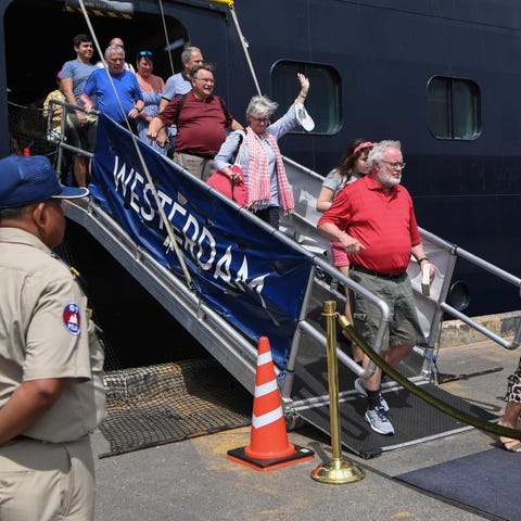 Passengers disembark from the Westerdam cruise shi