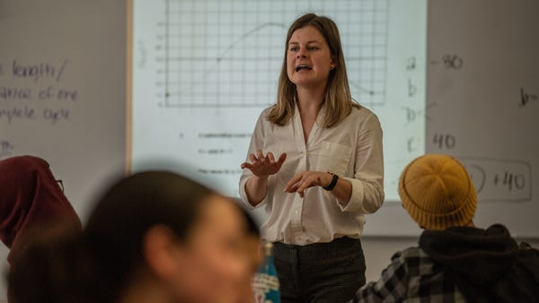 Math teacher Stephanie Hanson, 28, (center) works 