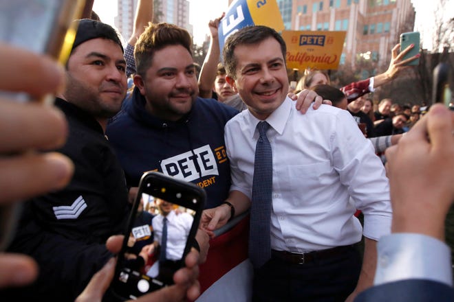 Democratic presidential candidate and former South Bend Mayor Pete Buttigieg poses for photos with supporters during a town hall rally in Sacramento, Calif., Friday, Feb. 14, 2020.