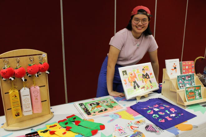 Jennifer Xiao presenting her illustrations turned into merchandise before her presentation.