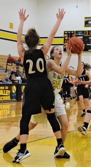 Tri-Valley's Anna Krupa goes up for a shot against Carrollton's Lauren Mormo in Saturday's 65-25 victory in Division II sectional play.