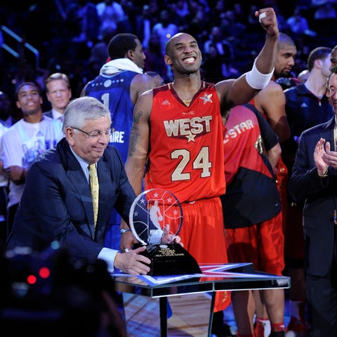 Kobe Bryant receives the 2011 All-Star MVP trophy 