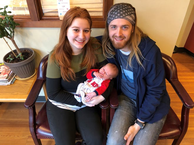 Nicole and Daniel Fahrnkopf hold their new baby Judah in Port Orchard. Nicole was unable to bank comp time because her supervisors said she couldn't perform her regular job at the Puget Sound Naval Shipyard while pregnant. She has filed a complaint.