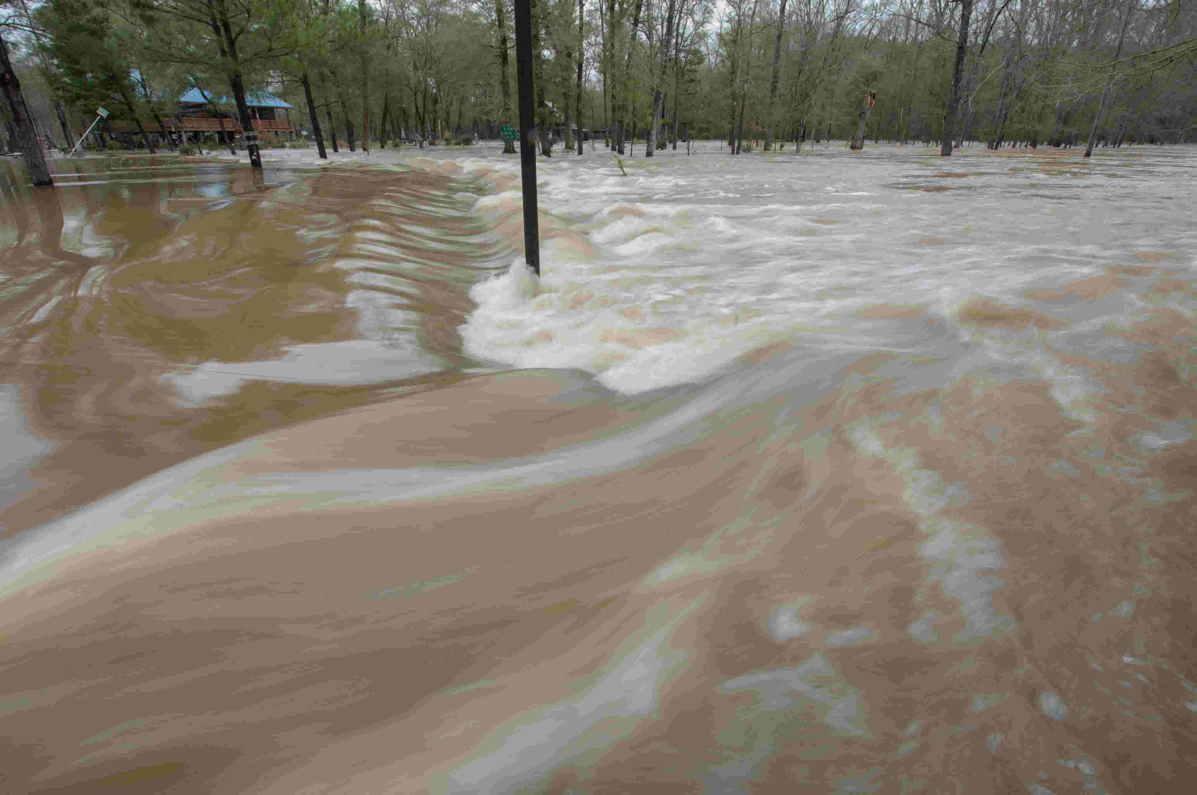 Pearl River flooding turns a front yard along FlorenceByram Road into