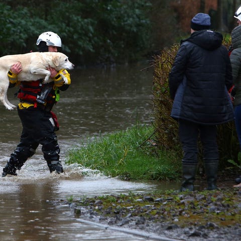 Members of the emergency services evacuate residen