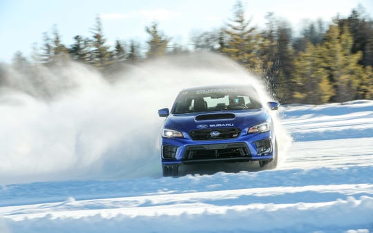 Thanks to its all-wheel-drive system and studded winter tires, the Subaru WRX STI negotiates turns at lurid 90-degree angles. 