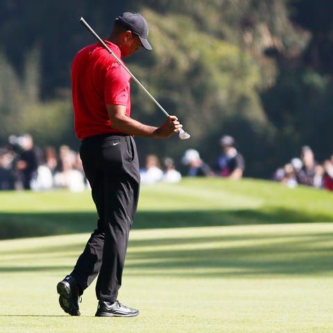Tiger Woods reacts to his approach shot on the 11t