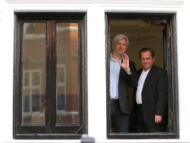 WikiLeaks founder Julian Assange, left, appears with Ecuador's then-Foreign Minister Ricardo Patino on the balcony of the Ecuadorian Embassy in London, Sunday, June 16, 2013.