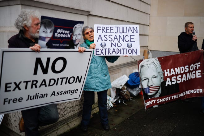 Supporters of WikiLeaks founder Julian Assange hold placards outside Westminster Magistrates Court in London on December 19, 2019.