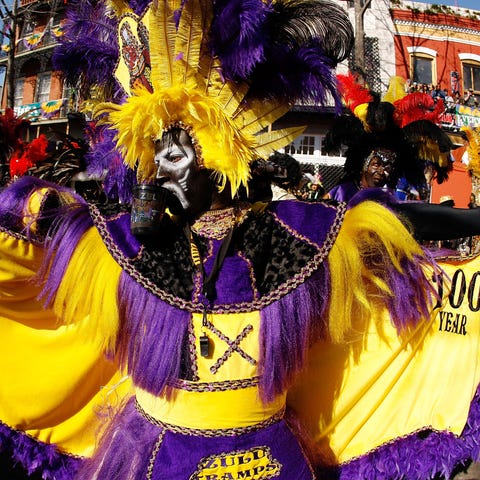 A member of the Zulu parade walks along St. Charle