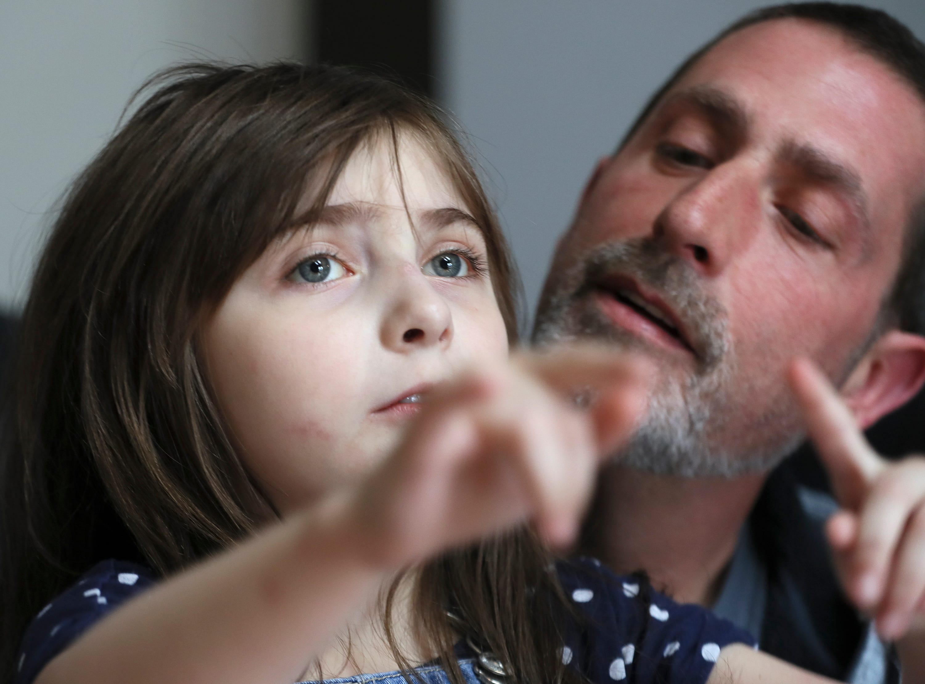 Brian Carroll works on communication with his daughter, Pepper, 7, who has autism and is nonverbal on Feb. 9, 2020.