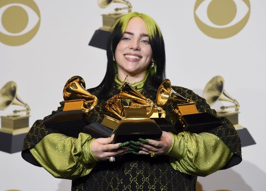 Billie Eilish poses in the press room with the awards for best album and best pop vocal album for "We All Fall Asleep, Where Do We Go?" best song and record for "Bad Guy" and best new artist at the 62nd annual Grammy Awards earlier this year in Los Angeles.