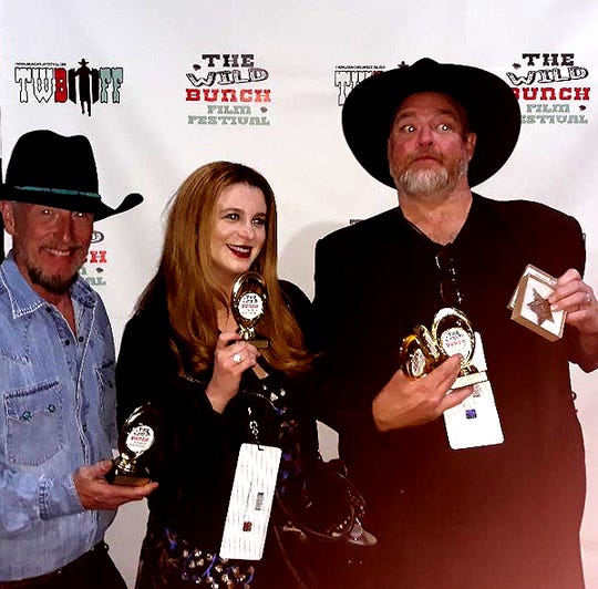 John Carter Cash, his wife Ana Cristina Cash and Eric Hamilton pose with Wild Bunch Film Festival trophies for "Dragon Song," a film John wrote, produced and won several awards for at the 2019 festival.
