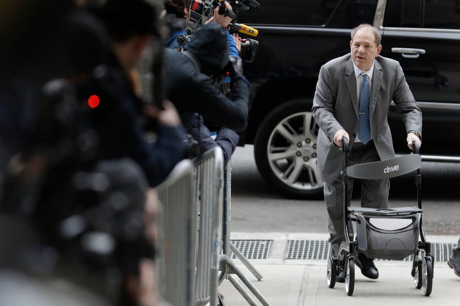 Harvey Weinstein greets reporters as he arrives at court for jury instructions in his sex crimes trial in New York on Feb. 18.