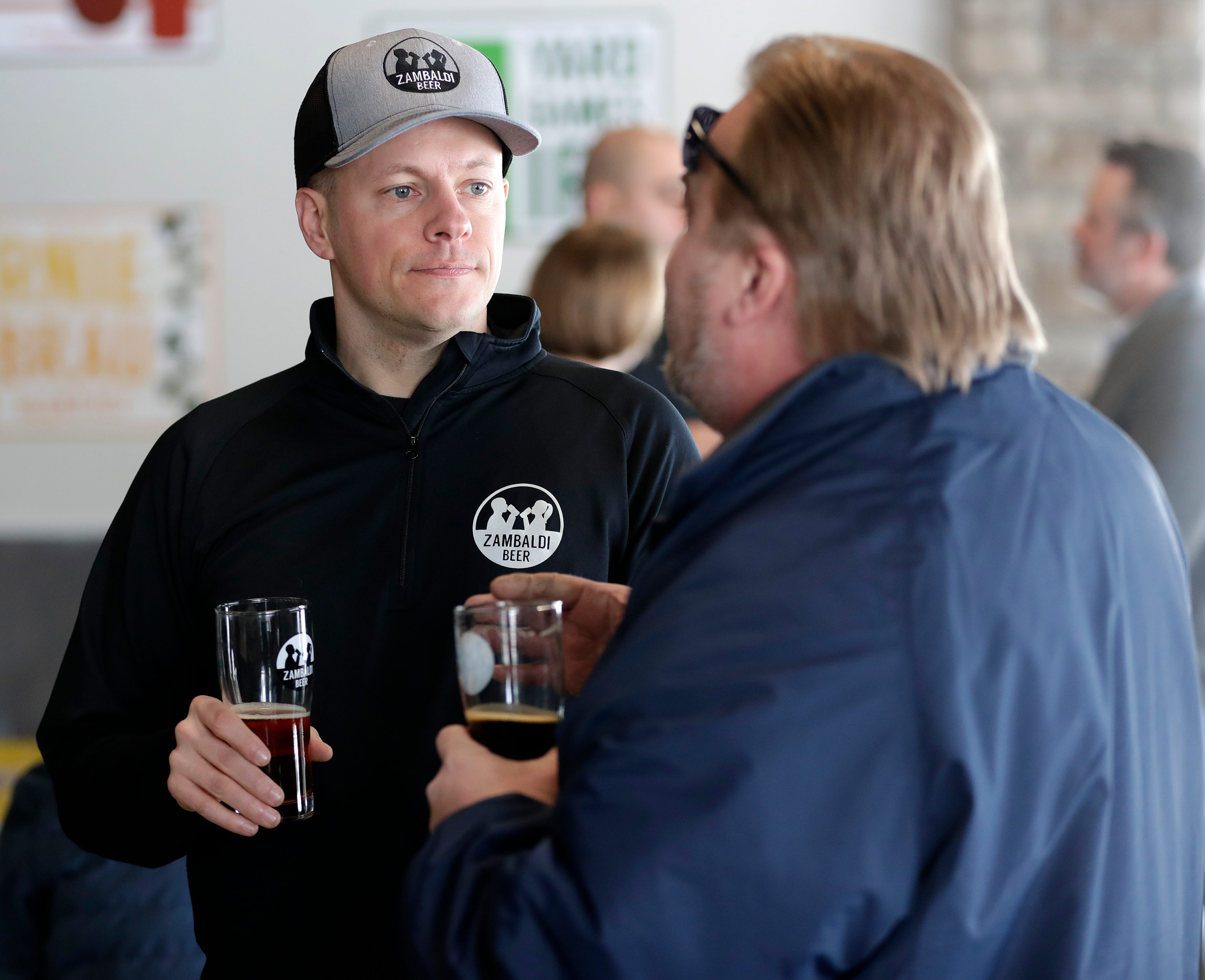 Wade Zander, a Zambaldi Beer founder and co-owner, talks with patrons during the brewery's grand opening in February. The brewery's name is a combination of Zander and Malcolm with baldi as a nod to Wade's and David's bald heads.