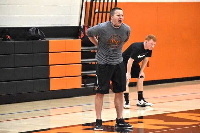 Central York boys' basketball coach Kevin Schieler yells out directions to his players during practice on Monday. Schieler's practice plan for the Panthers began his philosophy of starting a new season as the team begins district playoffs.