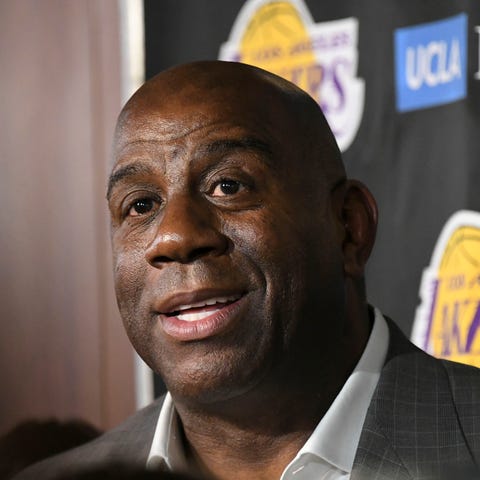 Magic Johnson speaks to the media before an April 