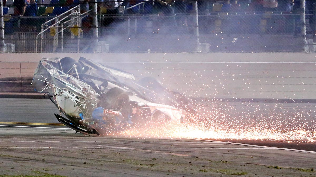 Fans at Daytona International Speedway stare in shock as Ryan Newman's No. 6 Ford goes skidding down the track upside-down in a shower of flames and sparks.