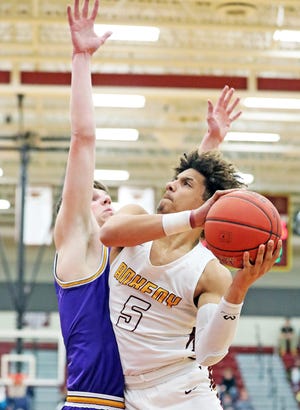 Ankeny senior Braxton Bayless (5) shoots around the tough defense of Johnston junior Max Roquet (44) as the Johnston Dragons compete against the Ankeny Hawks in high school boys’ basketball on Friday, February 14, 2020 at Ankeny High School. The Jaguars won 70 to 55.