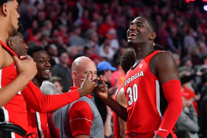 Georgia forward Mike Peake celebrates as he comes to the bench during the final moments of the team's NCAA college basketball game against Auburn, Wednesday, Feb. 19, 2020, in Athens, Ga. Georgia won 65-55. (AP Photo/John Amis)