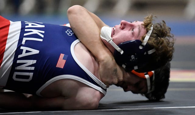 Oakland’s Evan Harris tries to keep from being pinned as he wrestles Summit’s Miles Grady during the TSSAA individual wrestling state championships at Williamson Co. Ag Center Thursday, Feb. 20, 2020 in Franklin, Tenn.