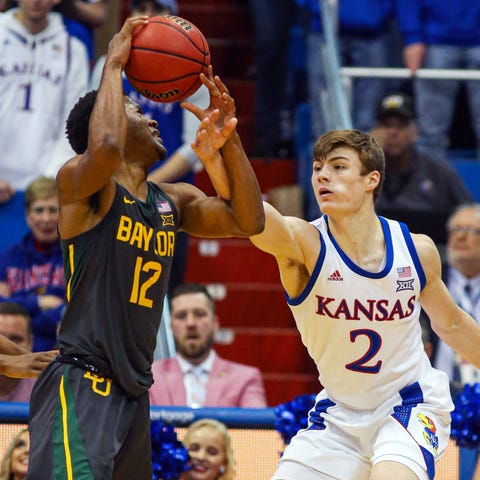 Bears guard Jared Butler (12) is fouled by Kansas 