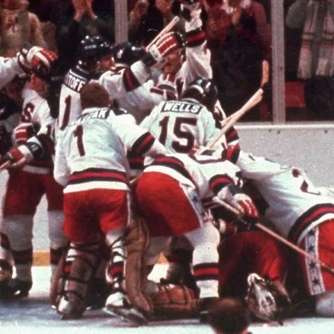 The U.S. hockey team pounces on goalie Jim Craig a