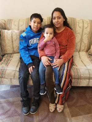 Vilma Diaz photographed with her two children, 11-year-old Axel and 2-year-old Josue. She will bring them with her to El Salvador when she is deported Saturday.