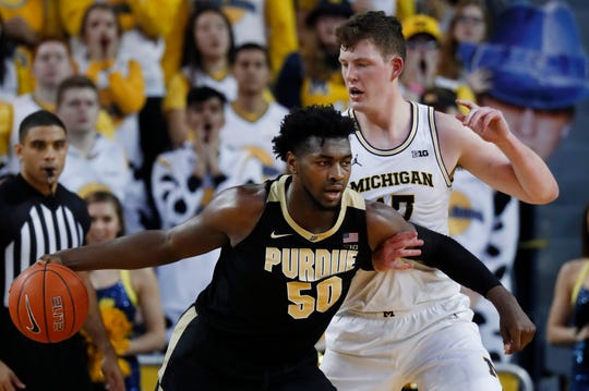 Trevion Williams drives on Jon Teske during the first Purdue vs. Michigan game in Ann Arbor on Jan. 9.