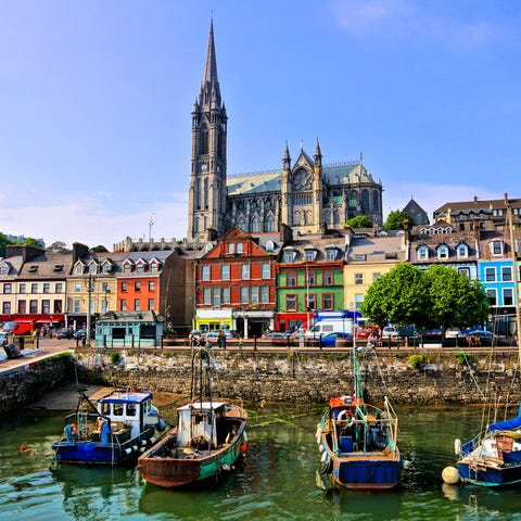 Colorful buildings and old boats with cathedral in