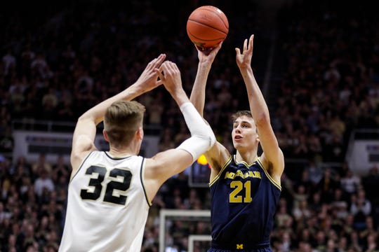 Michigan guard Franz Wagner shoots over Purdue center Matt Haarms during the first half in West Lafayette, Ind., Saturday, Feb. 22, 2020.