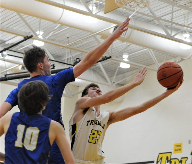 Tri-Valley's Jack Lyall puts up a layup against Philo's A.J. Clayton in Friday's 64-57 win. The Scotties clinched a share of the MVL title with the victory.