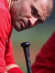 Cincinnati Reds first baseman Joey Votto (19) lifts his head off his bat during live batting practice, Sunday, Feb. 23, 2020, at the baseball team's spring training facility in Goodyear, Ariz. 