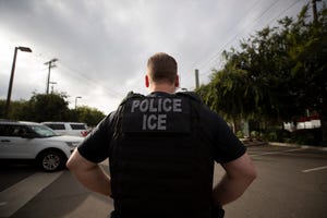 In this July 8, 2019, file photo, a U.S. Immigration and Customs Enforcement (ICE) officer looks on during an operation in Escondido, California.