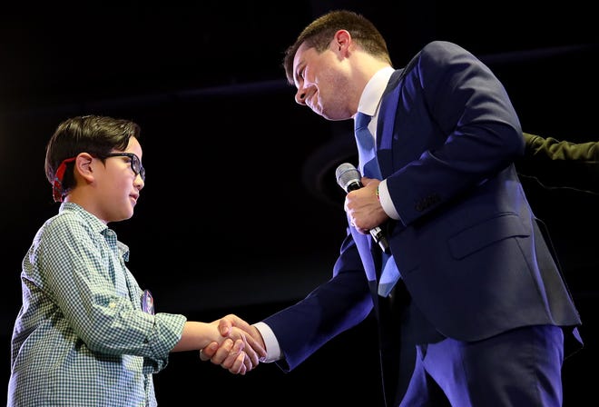 Democratic presidential candidate Pete Buttigieg greets Zachary Ro, who asked Buttigieg to help him tell others that he is gay, while the candidate spoke during an open discussion campaign event at the Denver Airport Convention Center on February 22, 2020.