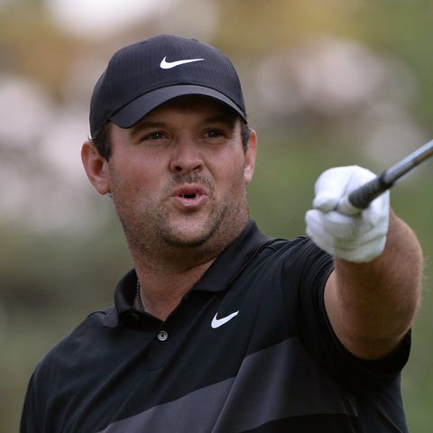Patrick Reed points with his iron during the final