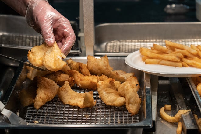 Fried cod is loaded into a station to be plated for customers during a fish fry at The United Methodist Church in Royal Oak. The fish fry is now in its 24th year.