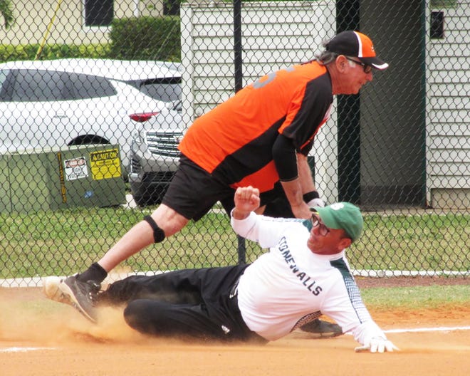 Stonewalls Jon Krebs slides in third base trying to beat the ball as Sand Barâ€™s Jerry Engel gets the putout.