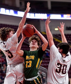 York Catholic's Luke Forjan, seen here at center in a file photo, is  the leading boys' basketball scorer in the York-Adams League at 24.3 points per game.