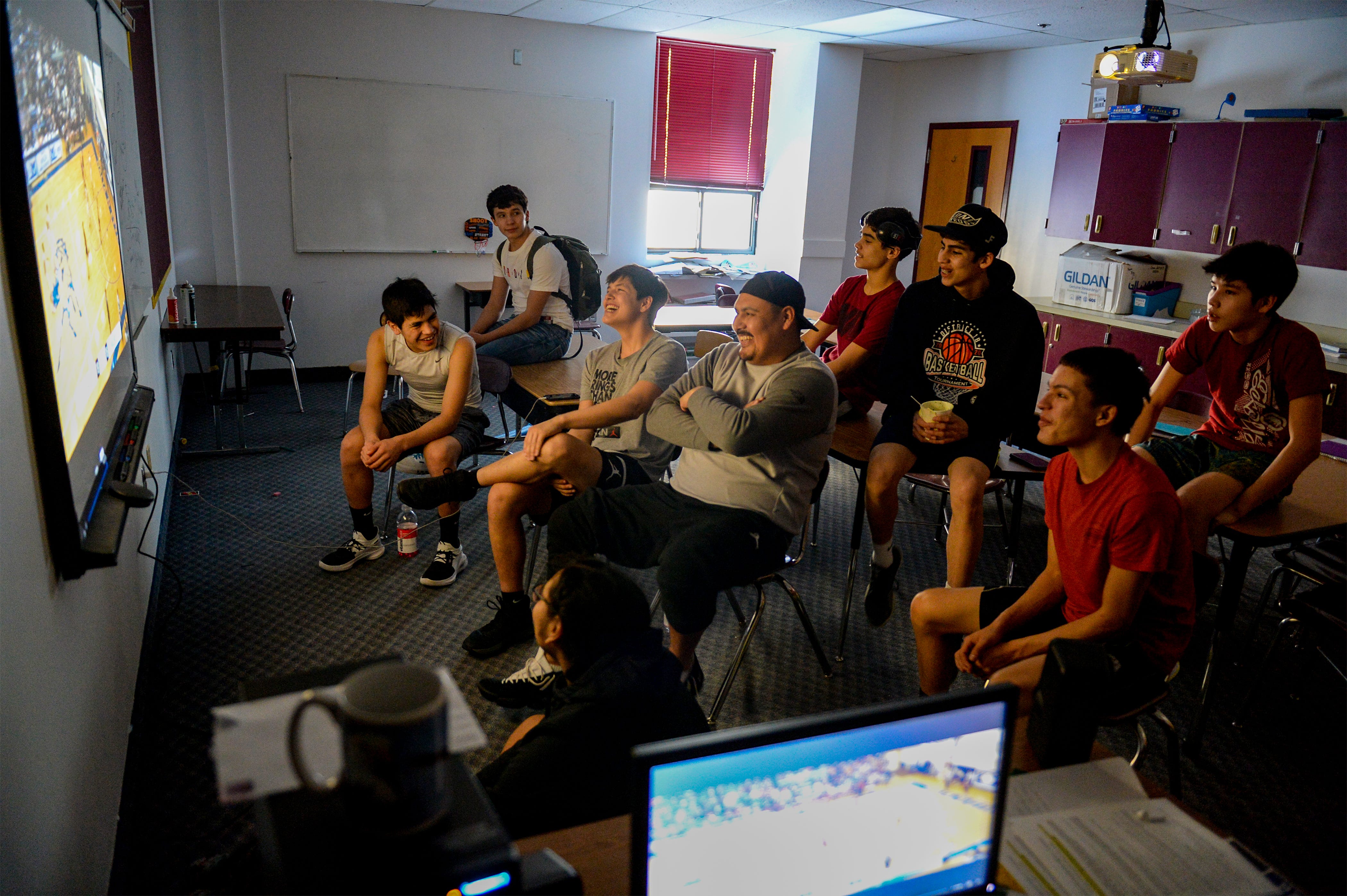 Once part of the Rocky Boy basketball team, Northern Stars head coach Adam Demontiney (middle), helps prepare the boys team for an upcoming game by watching footage.