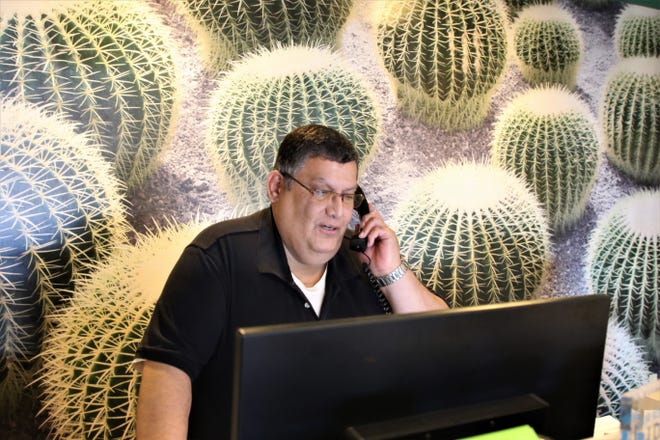 La Quinta Inns and Suites General Manager Tommy Salsberry takes a phone on Feb. 26, 2020 at the hotel located at 4020 National Parks Highway in Carlsbad.