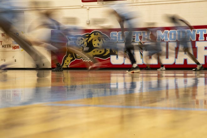 South Mountain team works out with their teammate at their school gym.