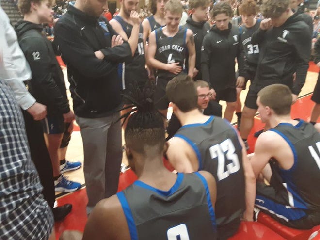Cedar Crest coach Tom Smith gives his team a few last-minute instructions before the start of the second half.