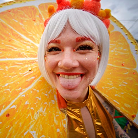 Reveler Anna Comarovschi is dressed as an orange s