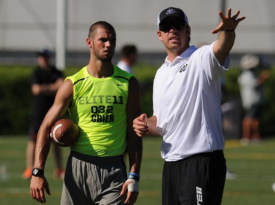 Jordan Palmer instructs Will Grier of Davidson, North Carolina, during the afternoon session of the Elite 11 at Nike World Headquarters in June 2013.