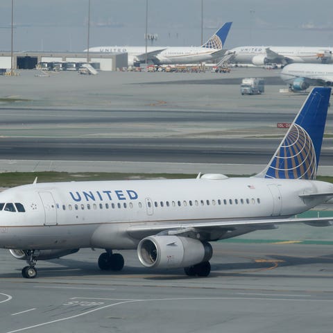 An United Airlines plane is shown on the tarmac fr